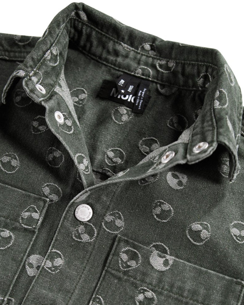 Dark denim jacket with alien pattern and visible brand label on a white background