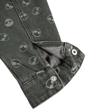 Close-up of dark gray fabric with circular patterns on a white background