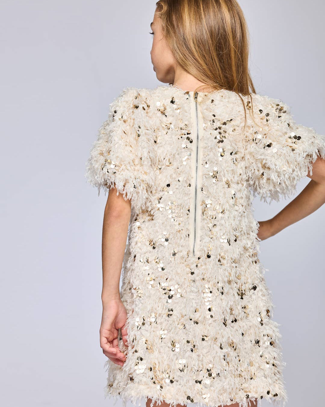 White lace dress with a zipper back on a plain background