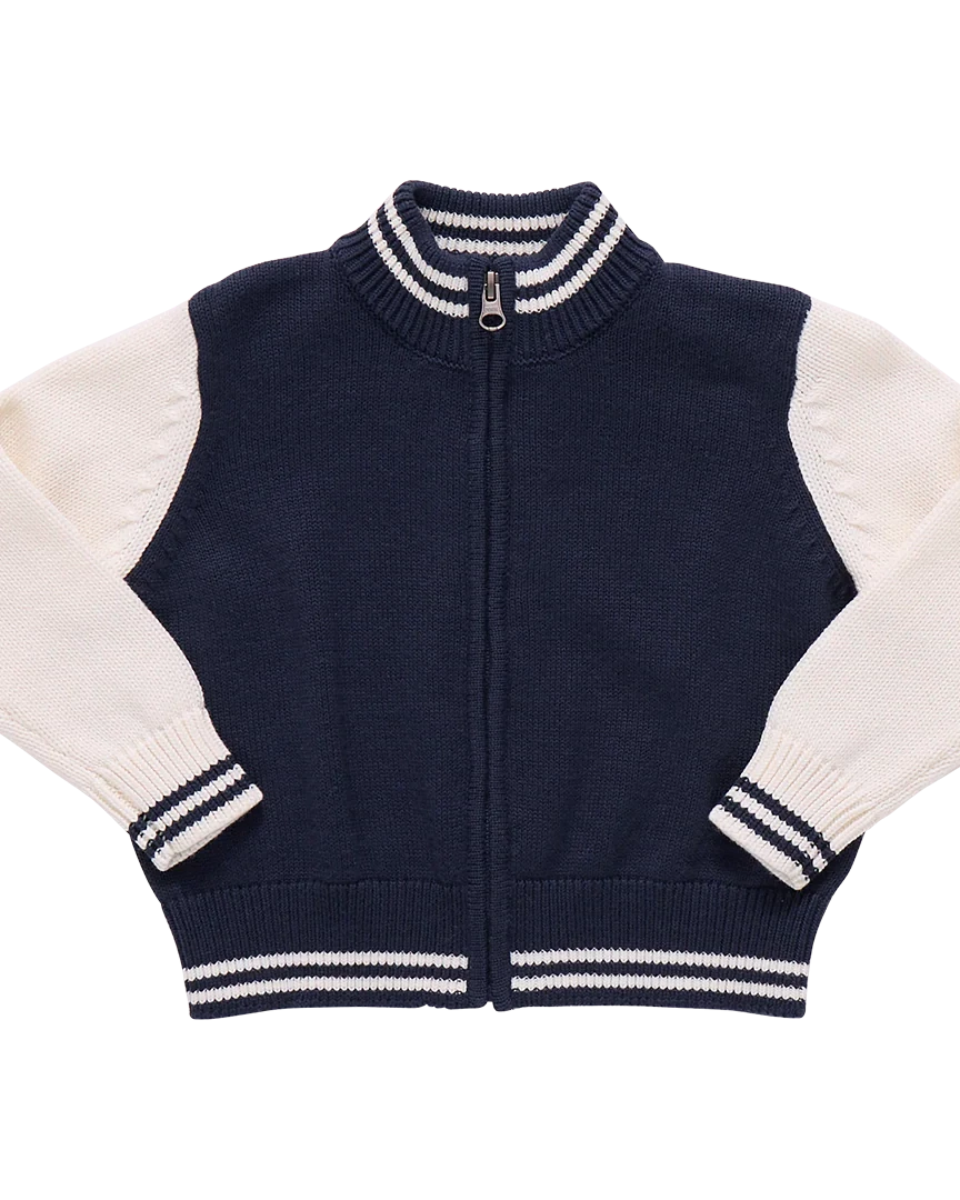 Navy blue and white zip-up sweater on a white background