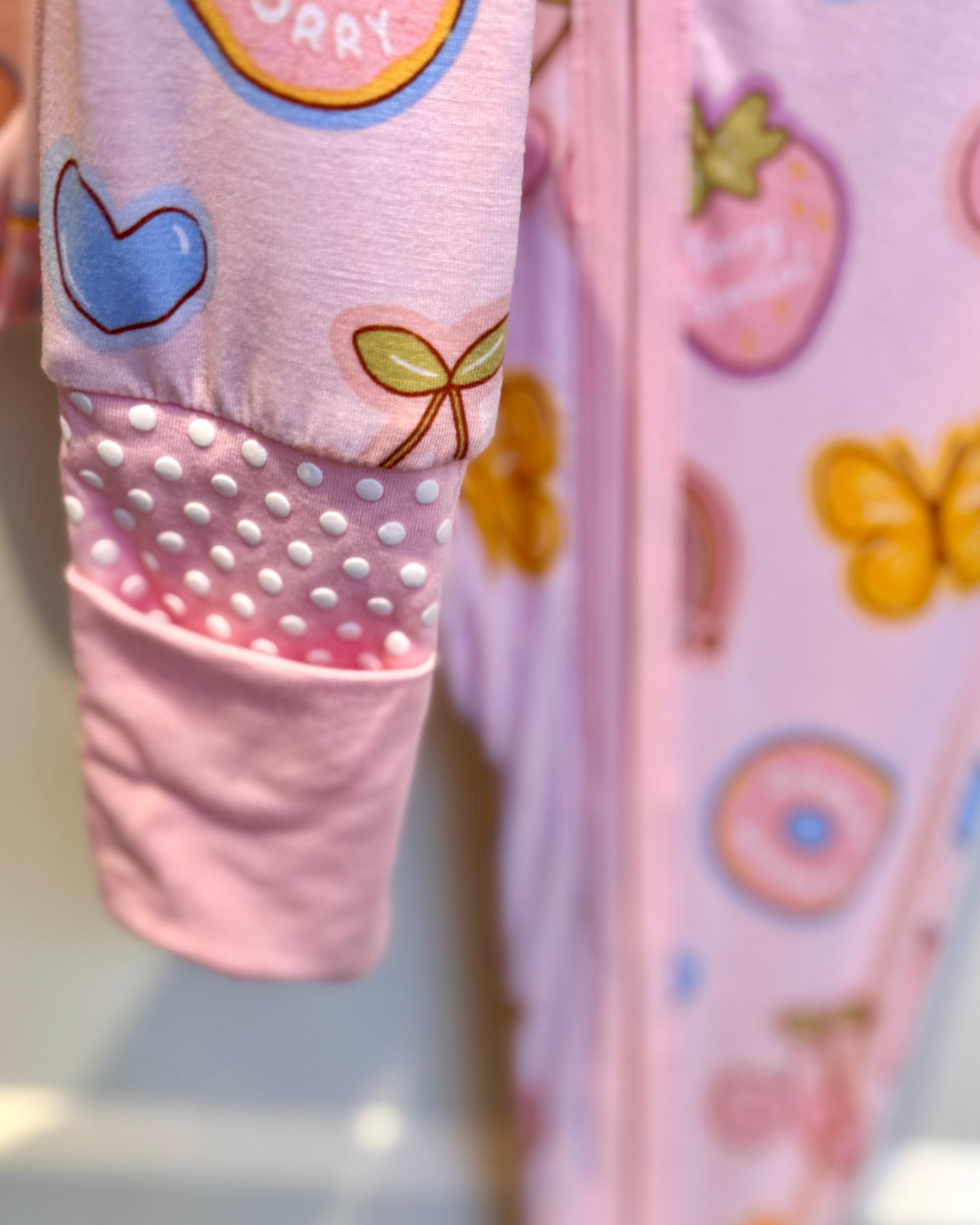 Children's pink leggings with colorful patterns on a white background