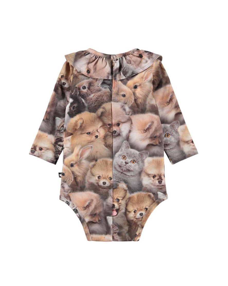 Baby onesie with a pattern of various animals on a white background