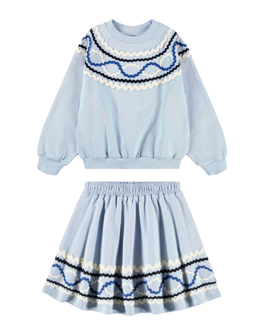 Light blue sweater and skirt set with decorative patterns on a white background