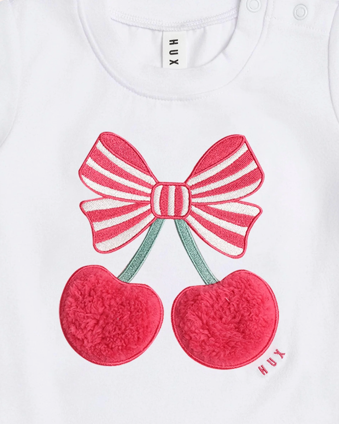 White shirt with red bow and cherries design, brand 'HUX' visible.