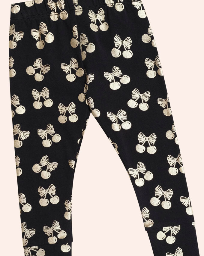 Black leggings with white bow pattern on a white background