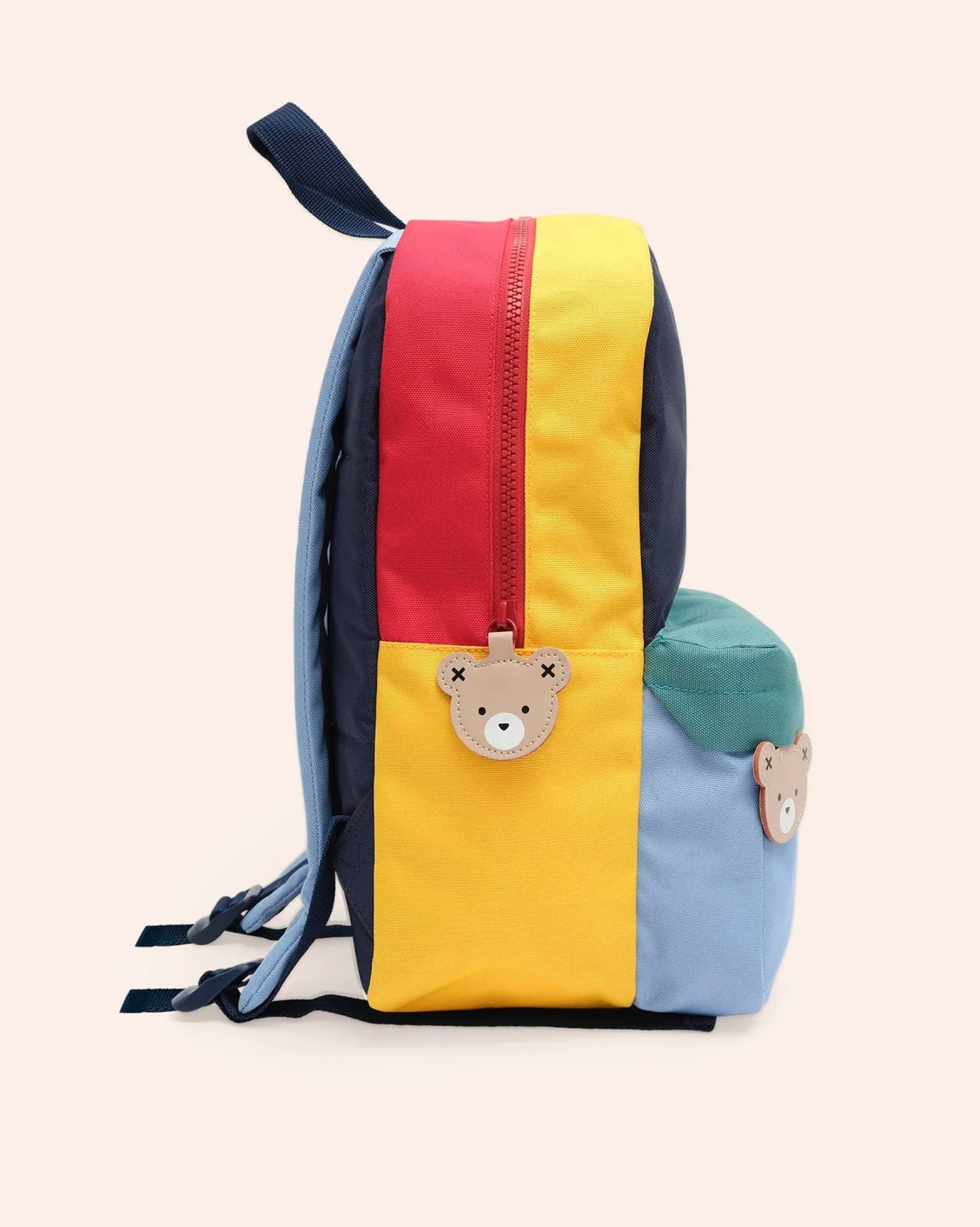 Colorful children's backpack with bear accents on a light pink background