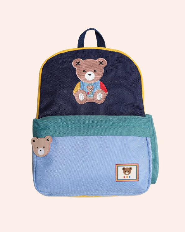 Backpack with teddy bear design on a beige background