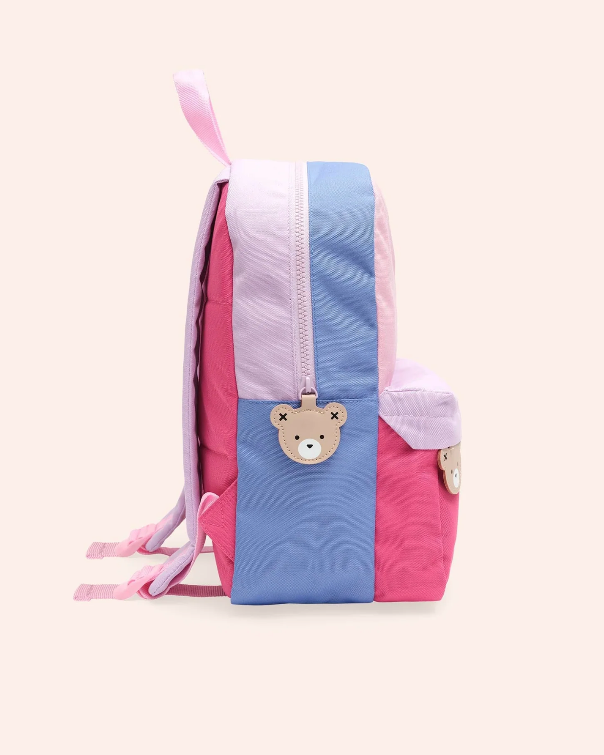 Children's backpack with pink and blue design on a light beige background