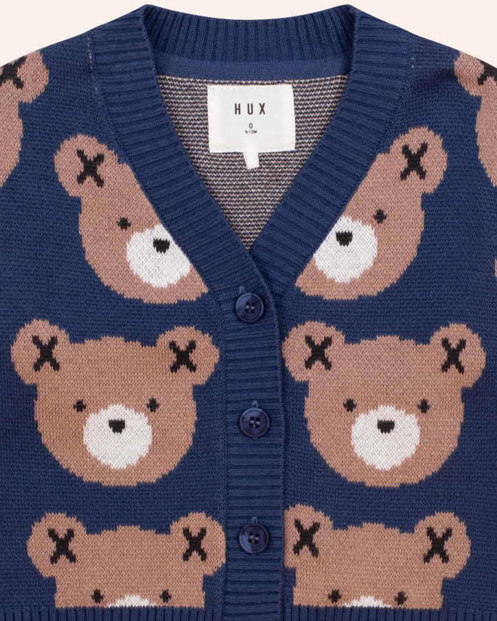 Navy blue cardigan with teddy bear pattern and HUX label.