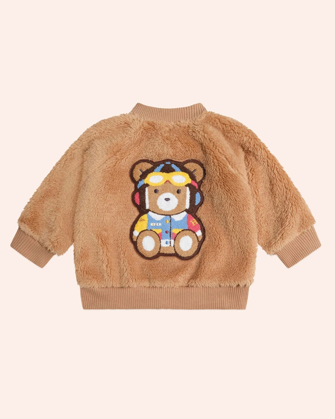 Brown teddy bear-themed jacket on a light pink background