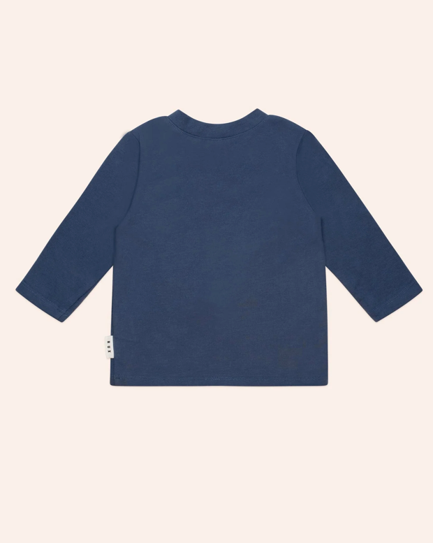 Navy blue long-sleeve shirt on a beige background