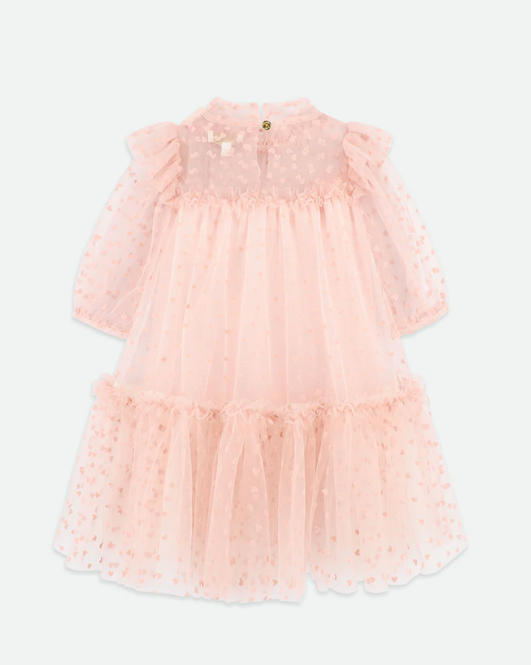 Pink dress with ruffled layers on a white background