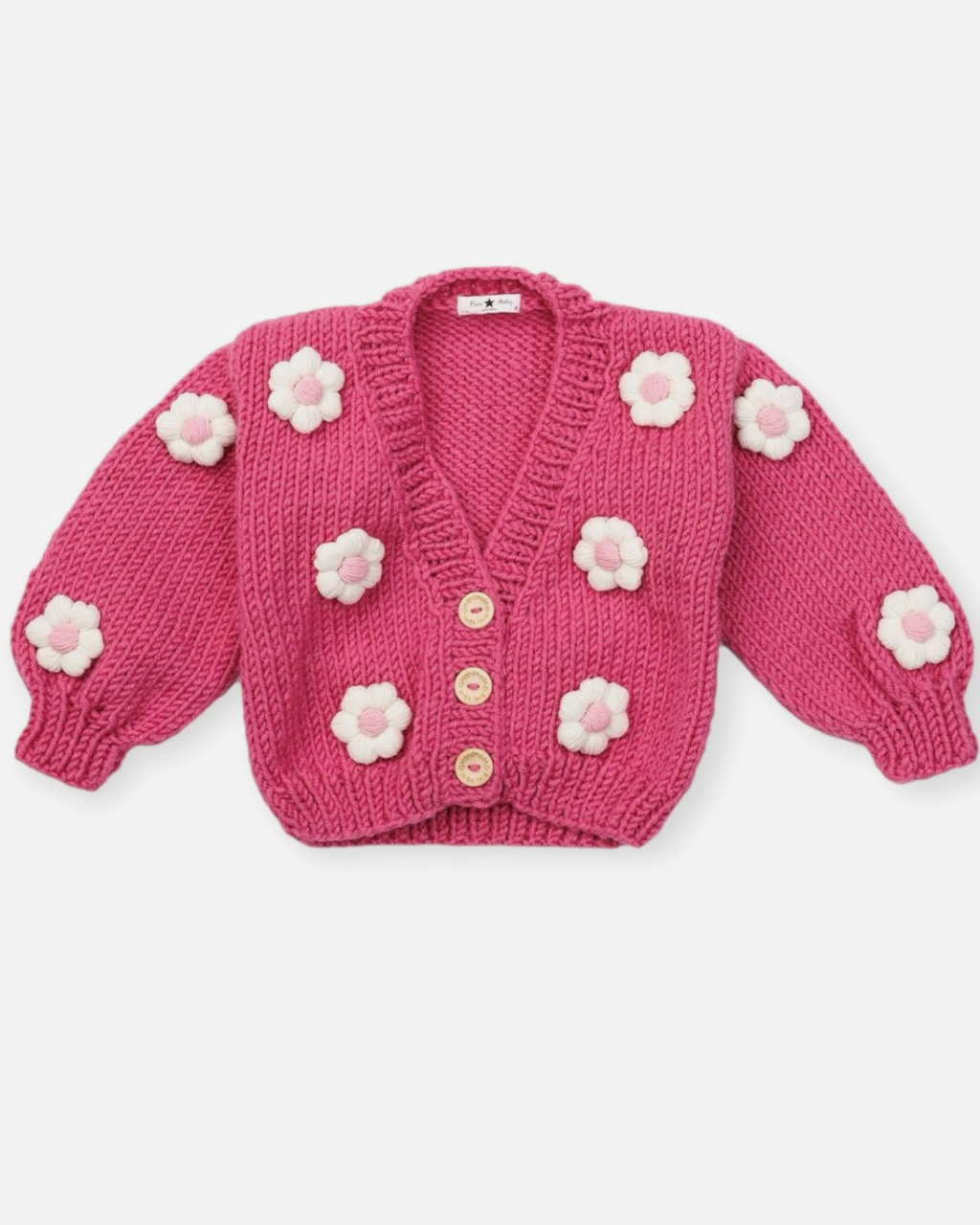 Pink knitted cardigan with floral details on a white background