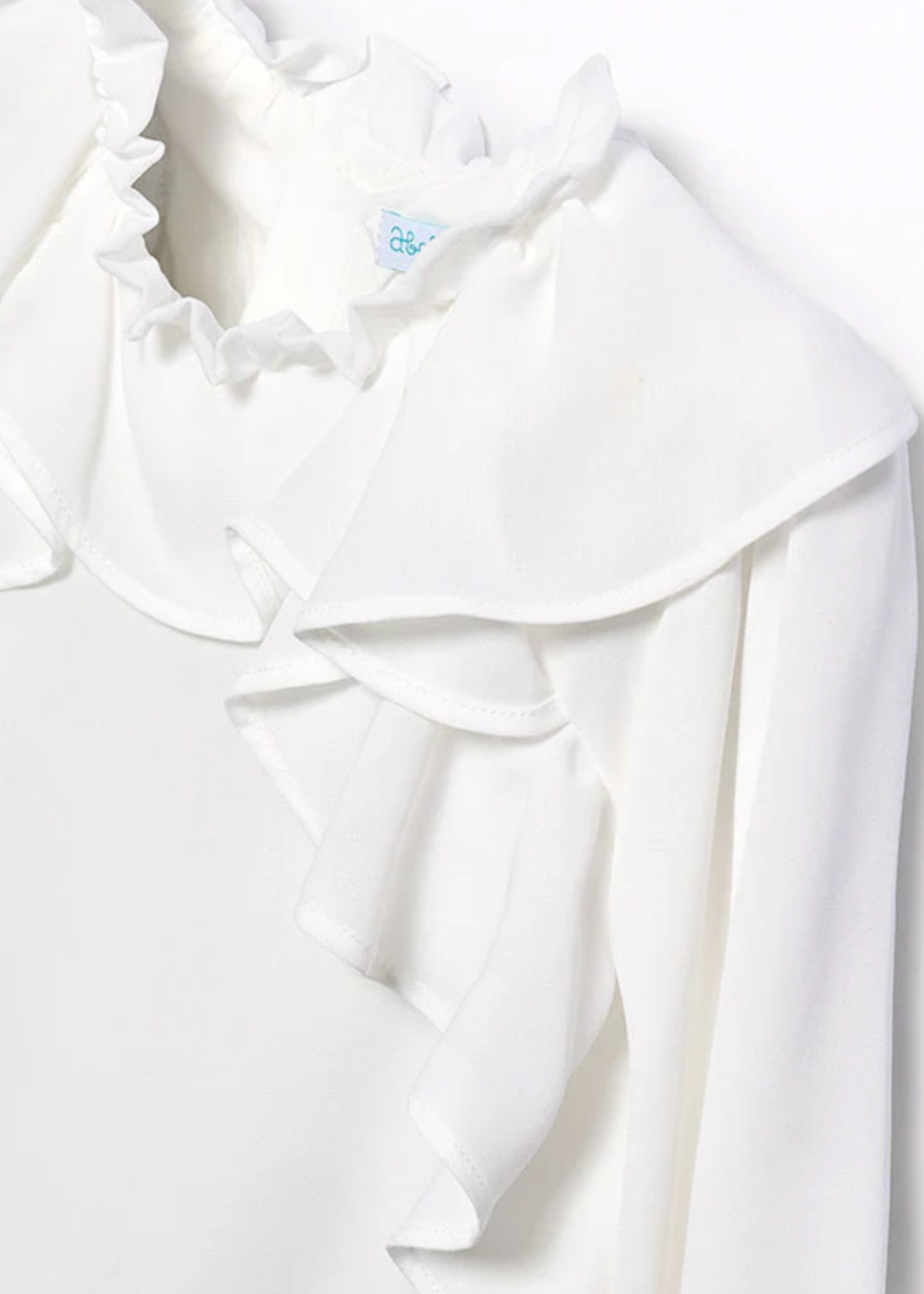 White blouse with ruffled collar on a white background