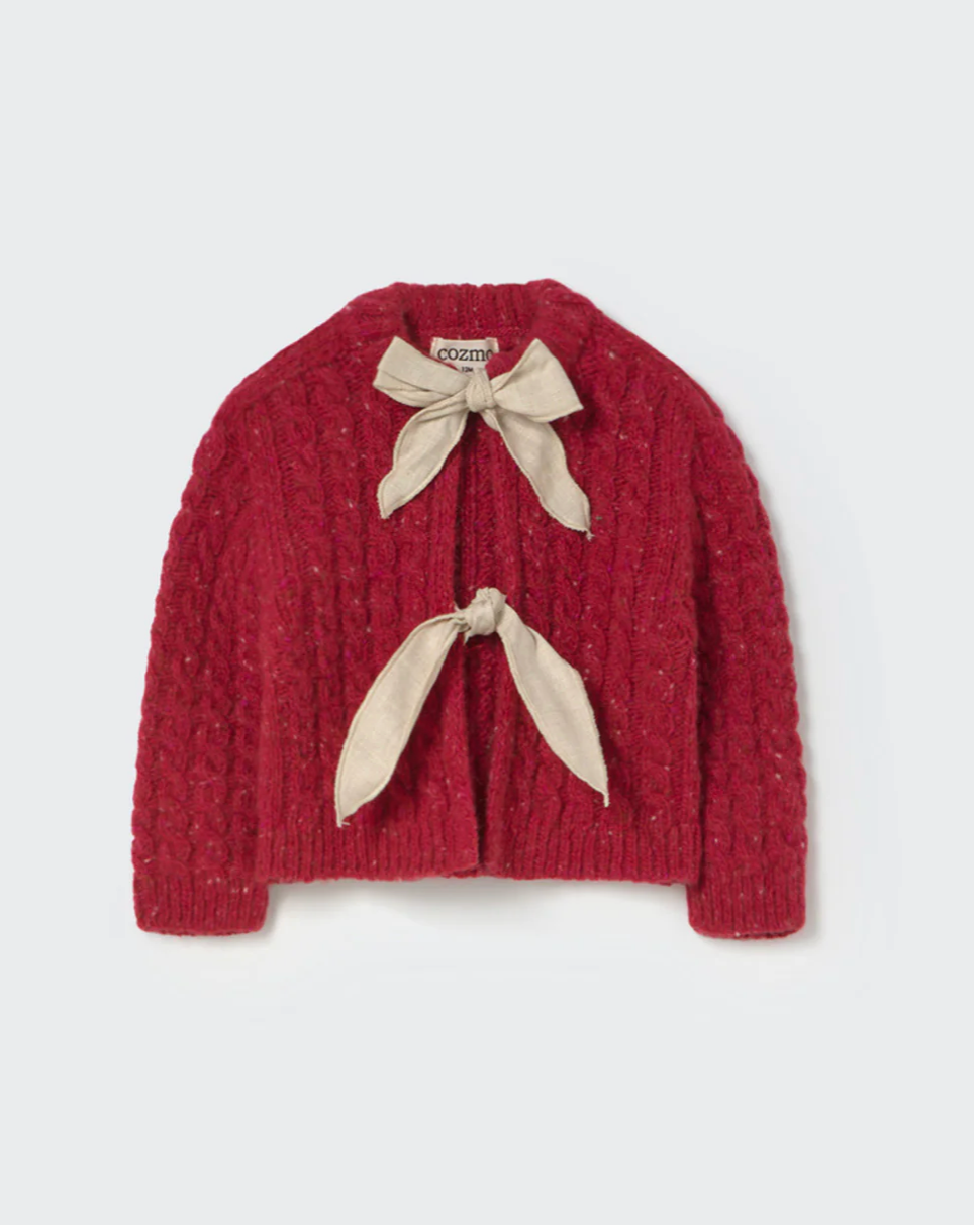 Red knitted sweater with beige ribbons on a white background