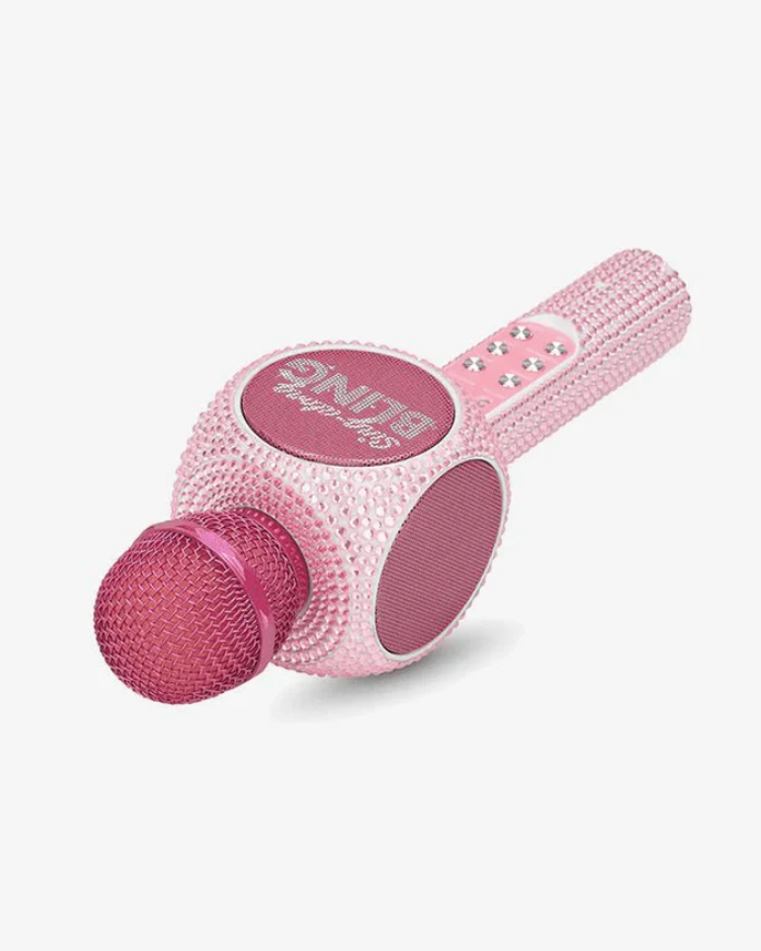 Pink toy microphone with glittery details on a white background