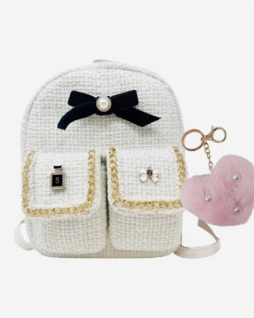 White backpack with a black bow and pink heart-shaped keychain on a white background