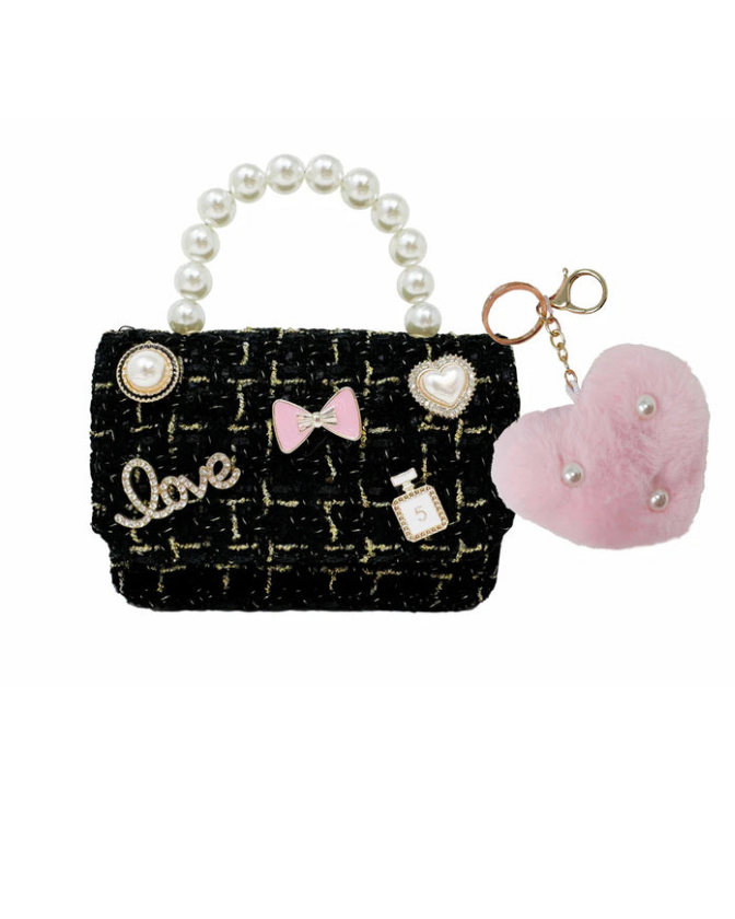 Black textured handbag with decorative elements on a white background