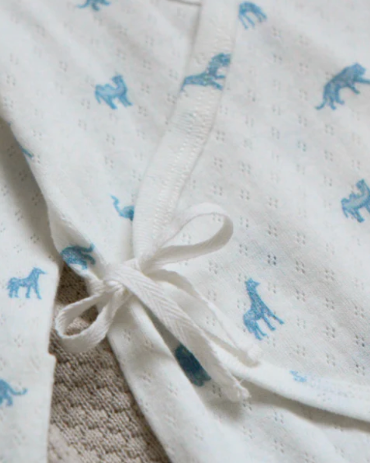 White fabric with blue elephant patterns and a tied knot.