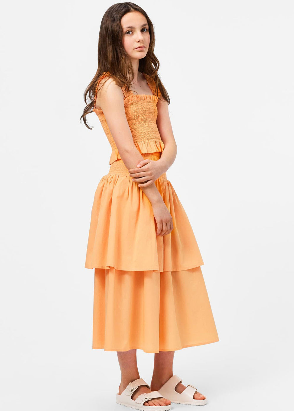Woman wearing an orange dress on a white background