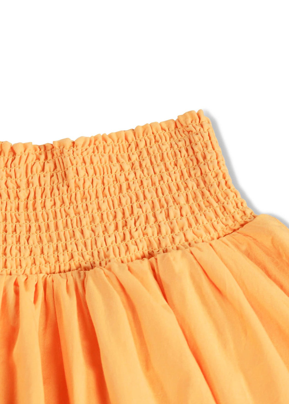 Close-up of an orange dress with smocked waistband on a white background
