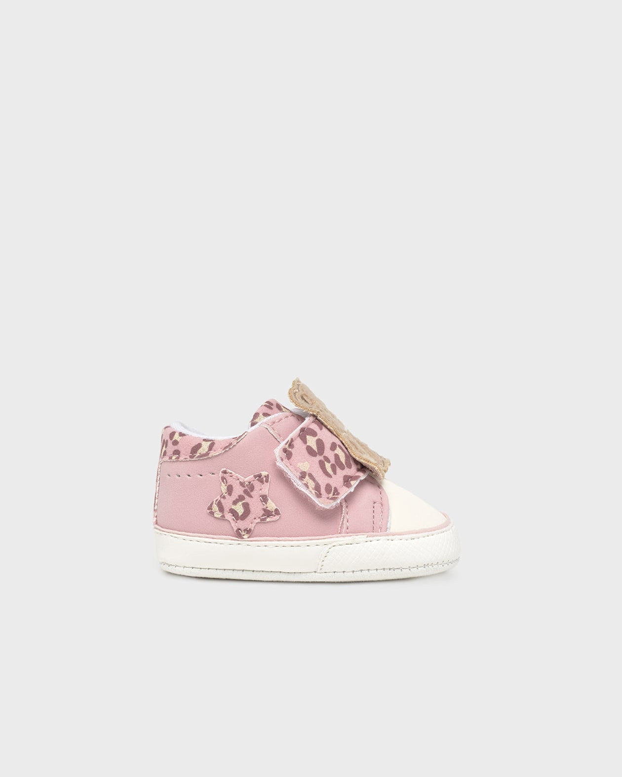 Pink children's sneakers with leopard print details on a white background