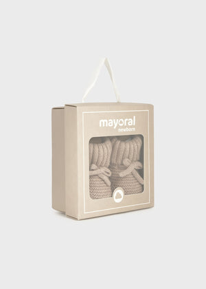 Beige sock packaging with 'mayoral' branding on a light gray background