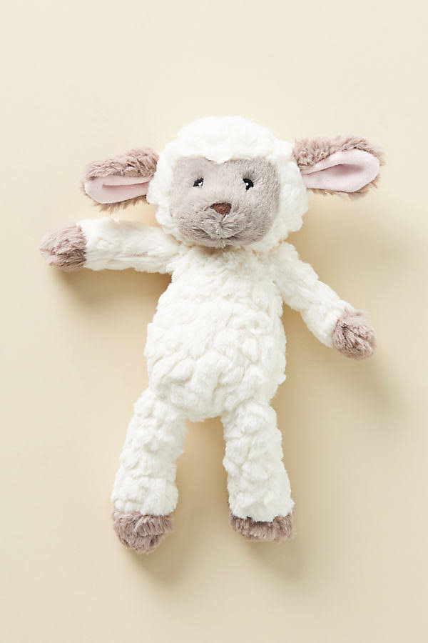 Stuffed toy sheep on a beige background
